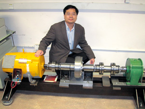 Professor Chau Kwok-tong and his invented magnetic gear setup.