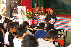 Leading actor Mr Lung Koon-tin guiding the students during a cultural exploration session in a bamboo shed opera house on Cheung Chau