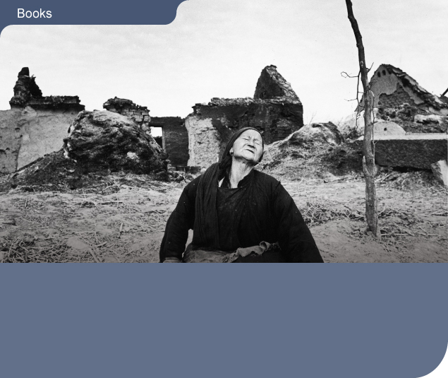 A grief-stricken woman stands amid the ruins of a village just north of Caolaoji, Anhui province, destroyed by fighting during the civil war.